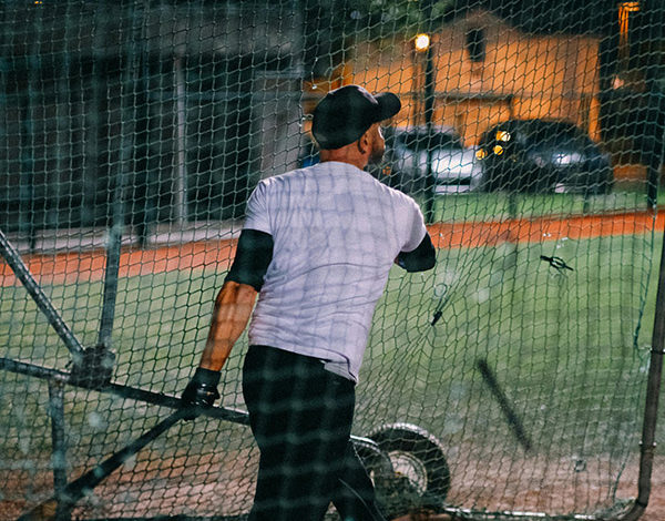 Back View of Man Holding a Baseball Bat