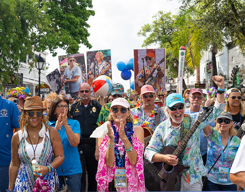 As fans blew bubbles and bounced beach balls, the Second Line Memorial Walking Parade honoring the late Jimmy Buffett proceeded along Duval Street in Key West, Fla., on Sunday, Aug. 31. Highlighting the island’s Just a Few Friends celebration, the march was led by a group including (front left) vocalist Nadirah Shakoor of Buffett’s Coral Reefer Band; (center front) his sister Lucy Buffett, renowned restaurateur and cookbook author; and (front right) Keys “trop-rock” musician Howard Livingston. (Photo credit: Nick Doll, Just a Few Friends)